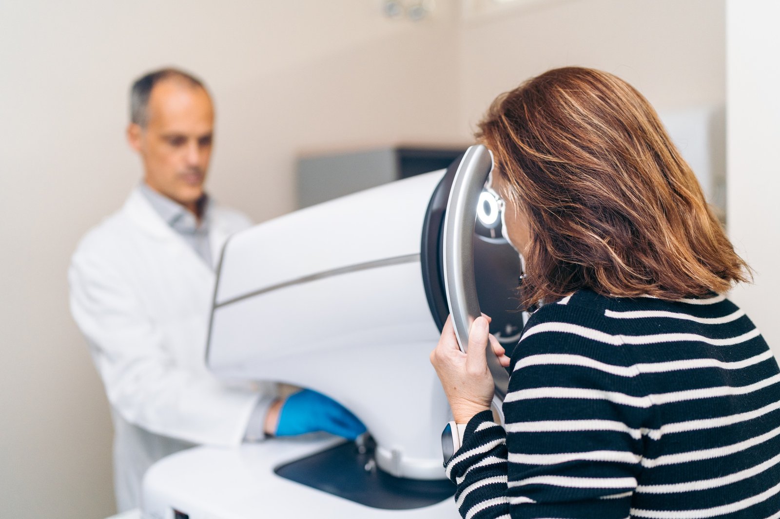 Woman Receives Comprehensive Eye Examination from Ophthalmologist Using Laser